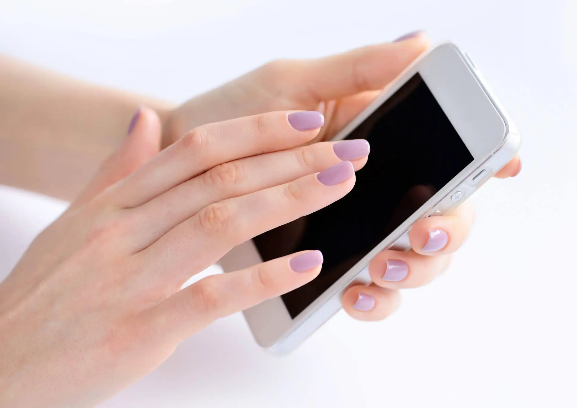 Person holding a phone in both hands, reading a message